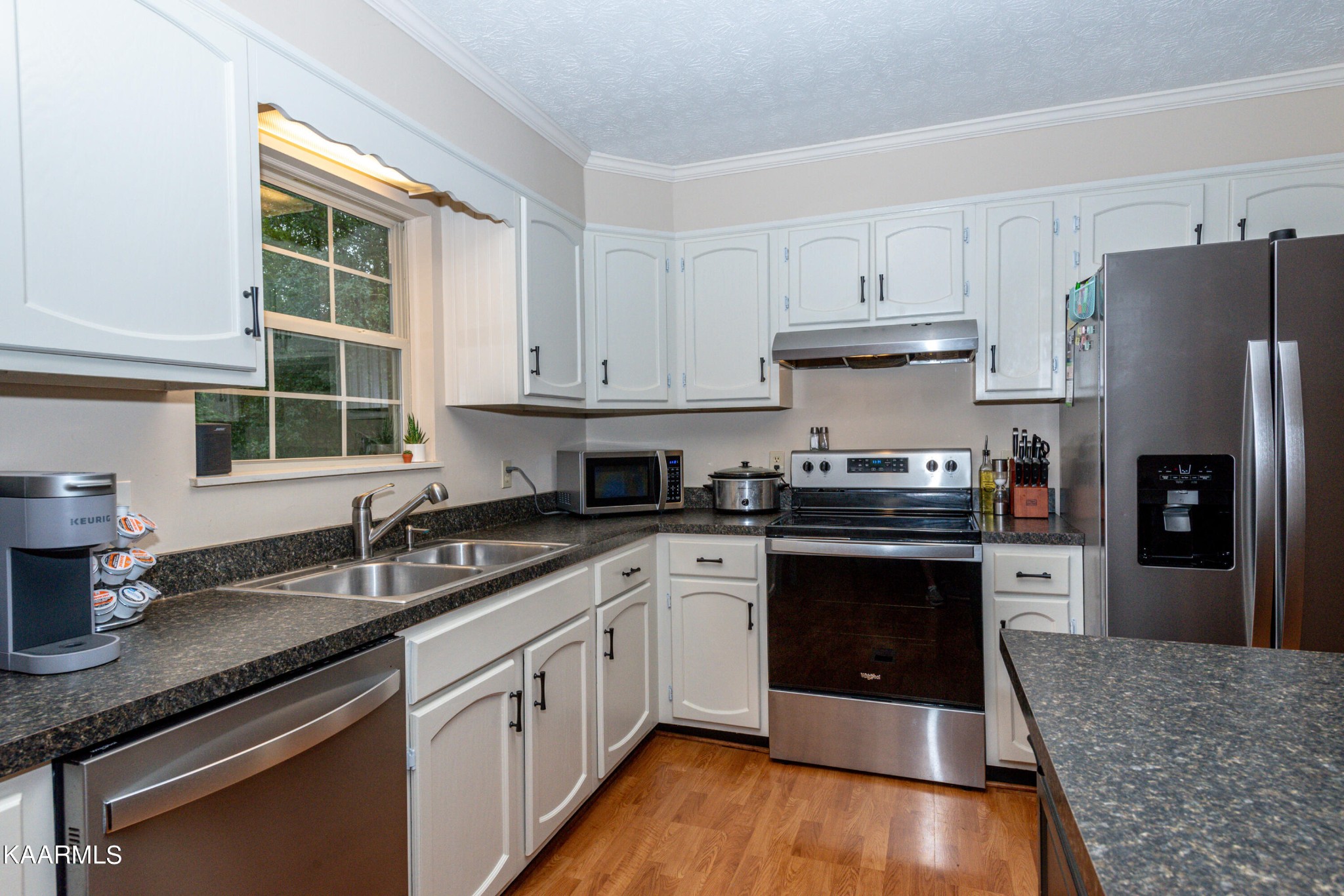 125 Lakeview Estates Road Vonore, TN 37885 - Photo 16 of 46 a kitchen with granite countertop a sink cabinets and stainless steel appliances