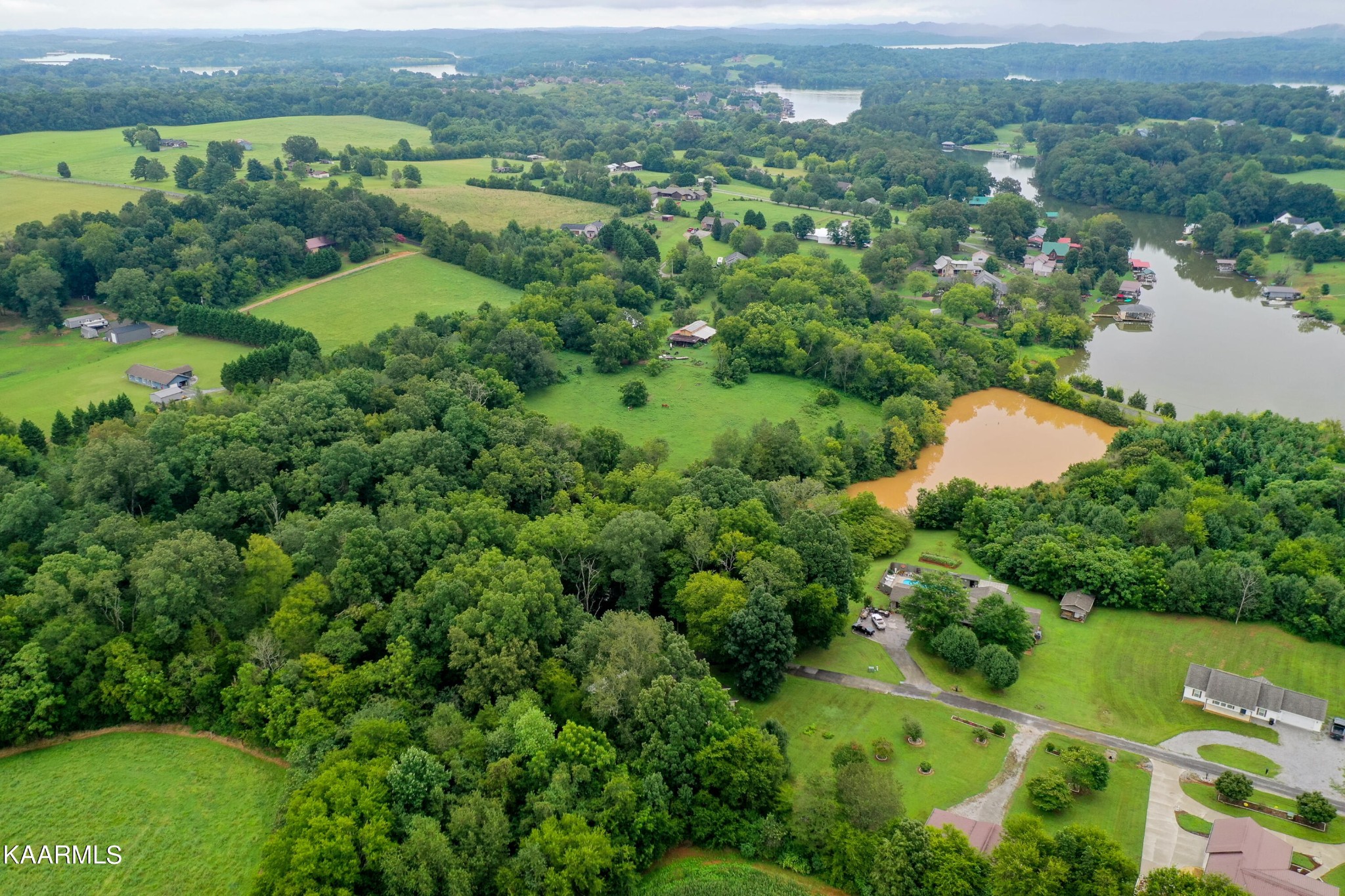125 Lakeview Estates Road Vonore, TN 37885 - Photo 42 of 46 an aerial view of green landscape with trees houses and mountain view