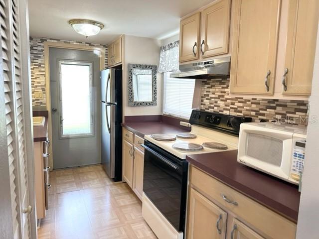 7701 Starkey Road, Unit 731 Seminole, FL 33777 - Photo 4 of 19 a kitchen with a stove cabinets and wooden floor