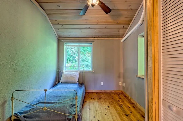 a bedroom with a bed and a window