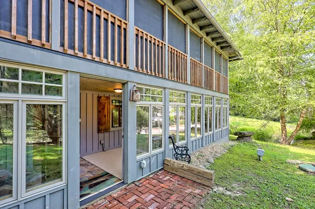 a yellow house sitting in middle of the forest