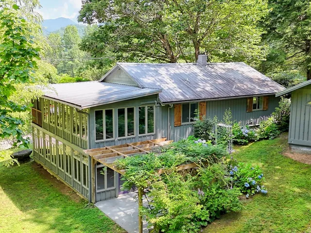 a backyard of a house with garden and deck