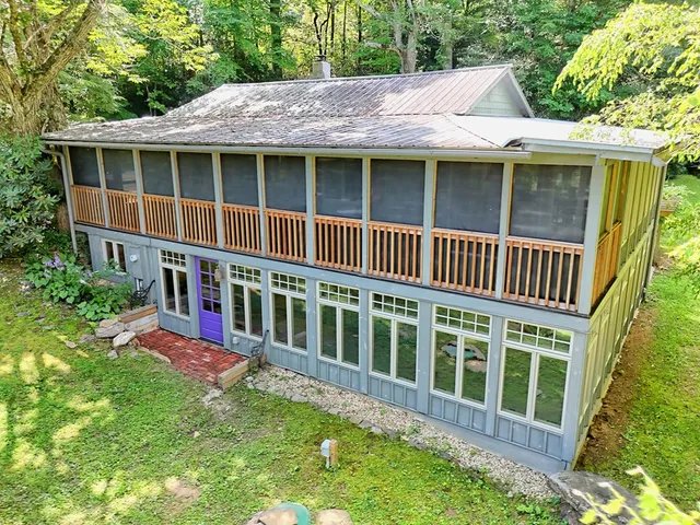 a view of a house with a yard and sitting area