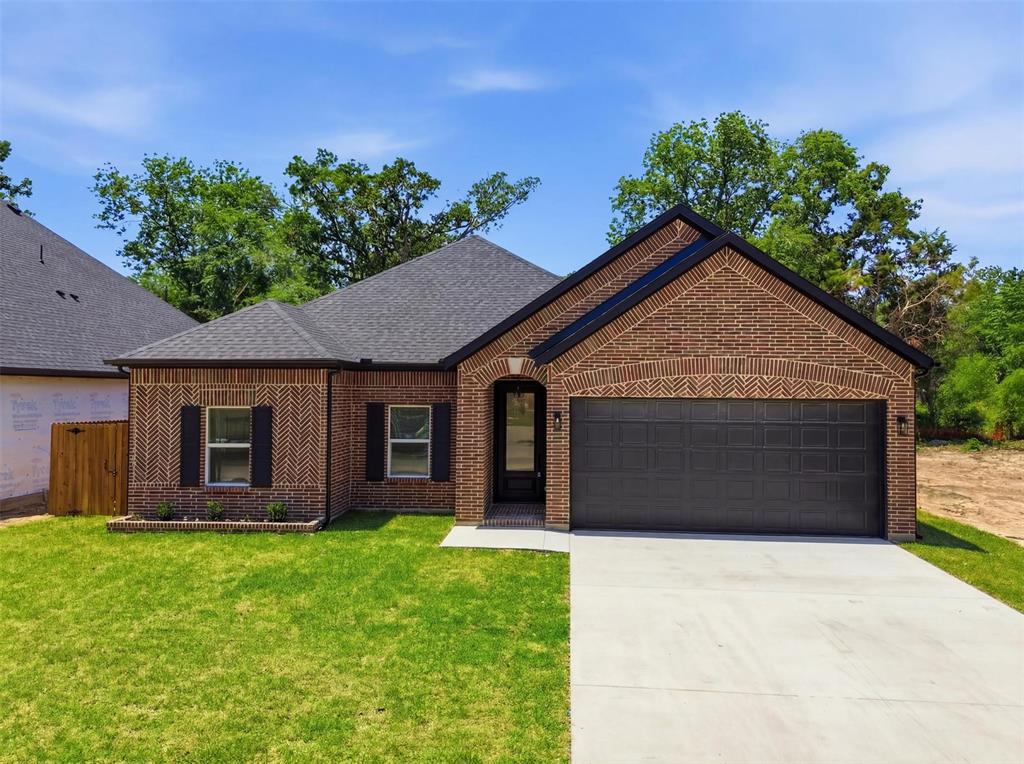 435 Waterboard Road Trinidad, TX 75163 - Photo 1 of 39 Brick exterior with contrasting dark trim, a dark asphalt shingle roof, and a two-car garage