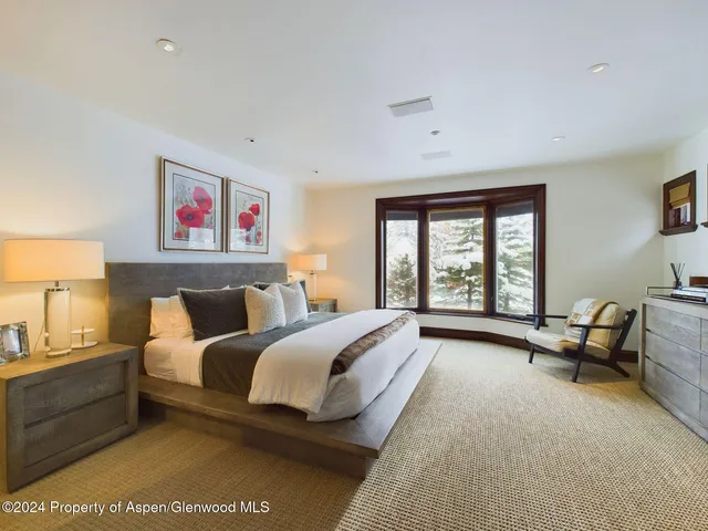 a view of a hallway with wooden floor and windows