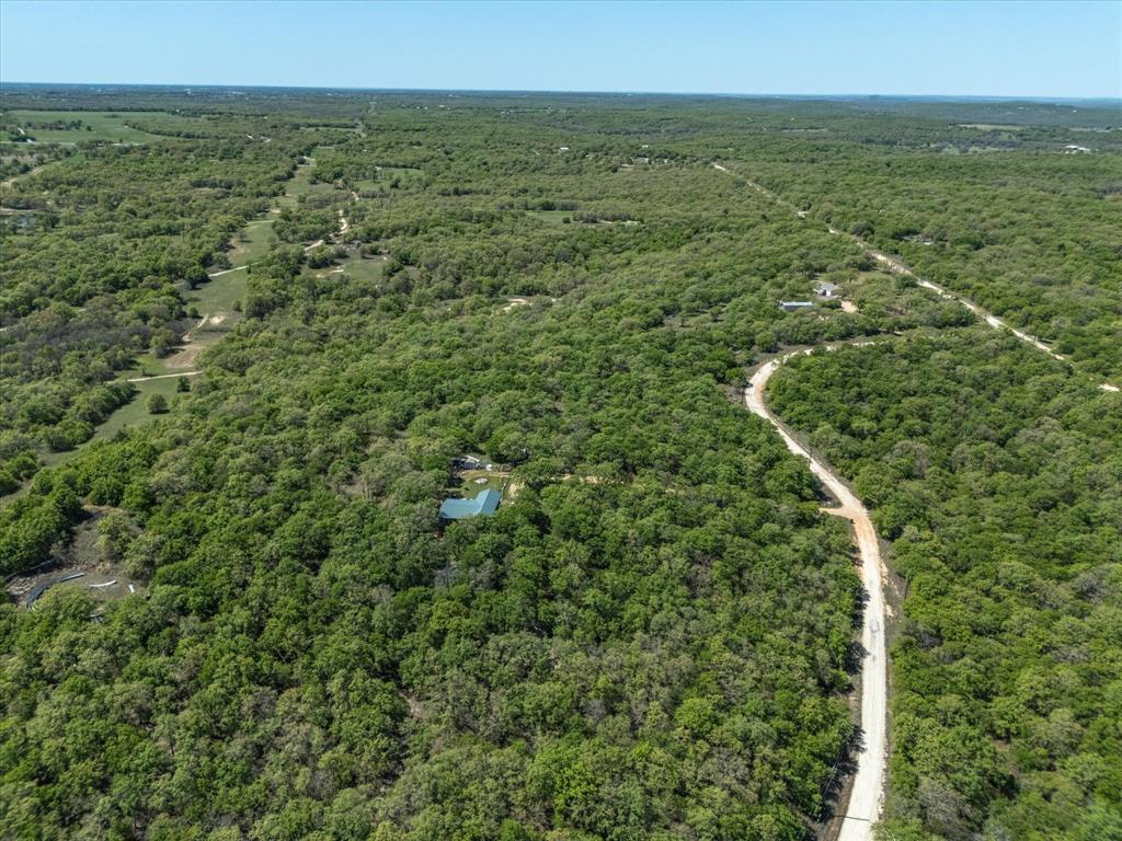 900 Old Spring Road Nocona, TX 76255 - Photo 11 of 27 an aerial view of residential houses with outdoor space and trees