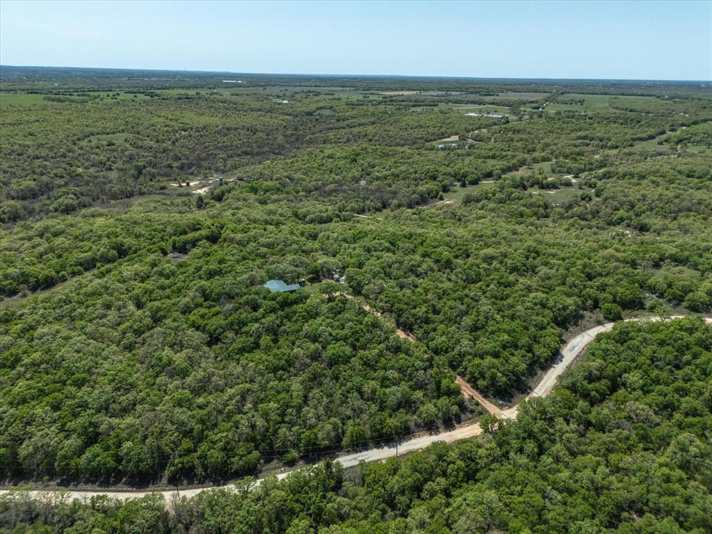 900 Old Spring Road Nocona, TX 76255 - Photo 12 of 27 an aerial view of residential houses with outdoor space and trees all around
