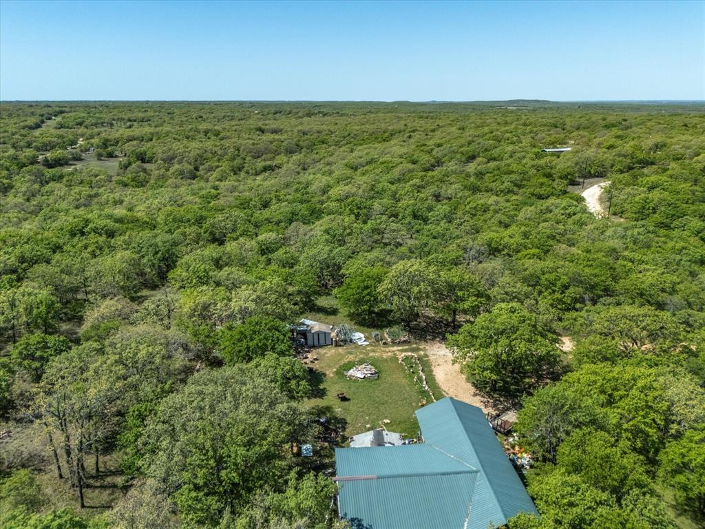 900 Old Spring Road Nocona, TX 76255 - Photo 2 of 27 an aerial view of residential houses with outdoor space and trees