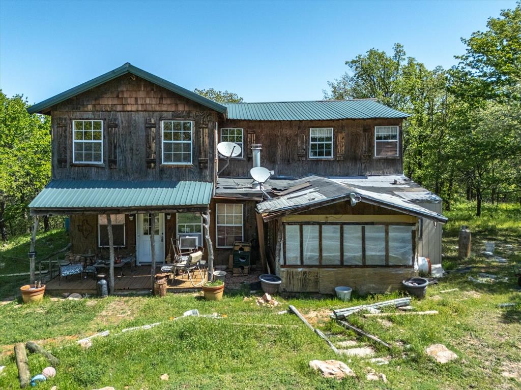 900 Old Spring Road Nocona, TX 76255 - Photo 3 of 27 a front view of a house with a yard
