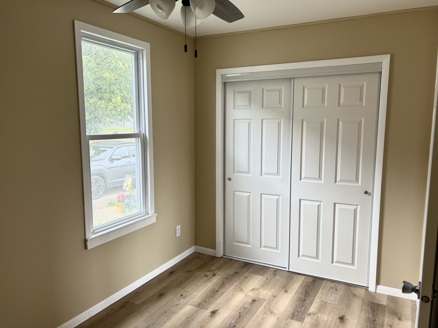 105 West 2nd Street Spring Valley, IL 61362 - Photo 13 of 18 a view of an empty room with a window and wooden floor