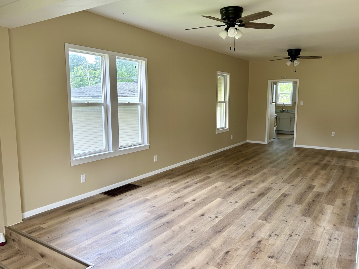 105 West 2nd Street Spring Valley, IL 61362 - Photo 2 of 18 a view of an empty room with a window and wooden floor
