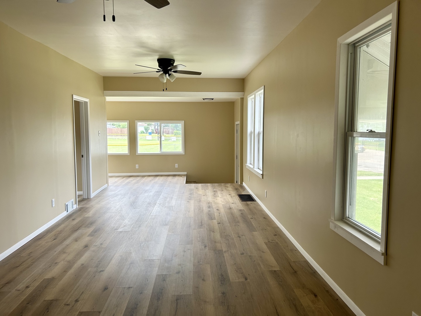 105 West 2nd Street Spring Valley, IL 61362 - Photo 3 of 18 wooden floor in an empty room with a window