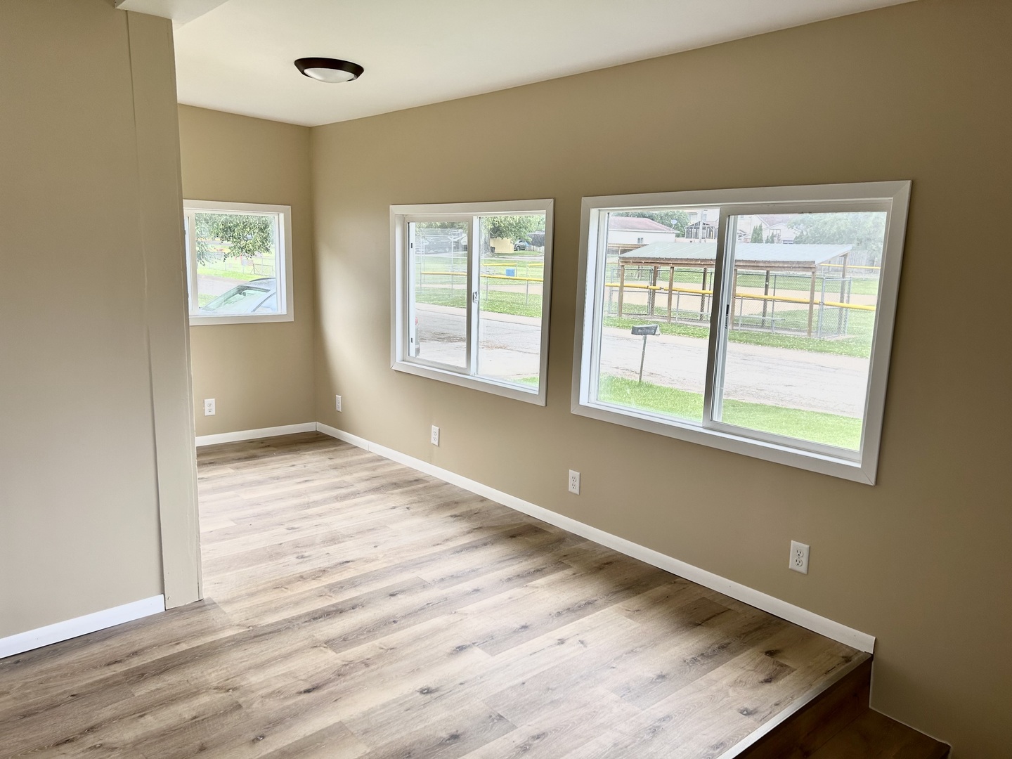 105 West 2nd Street Spring Valley, IL 61362 - Photo 4 of 18 an empty room with wooden floor and windows