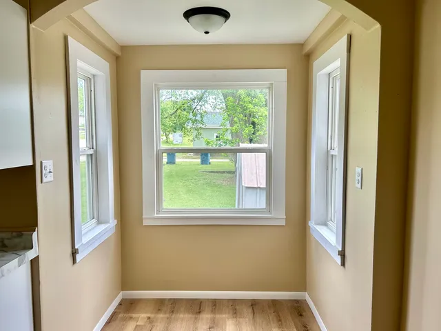 a view of an empty room with a window and a window