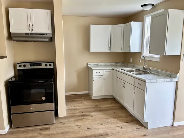 a kitchen with a stove and a microwave