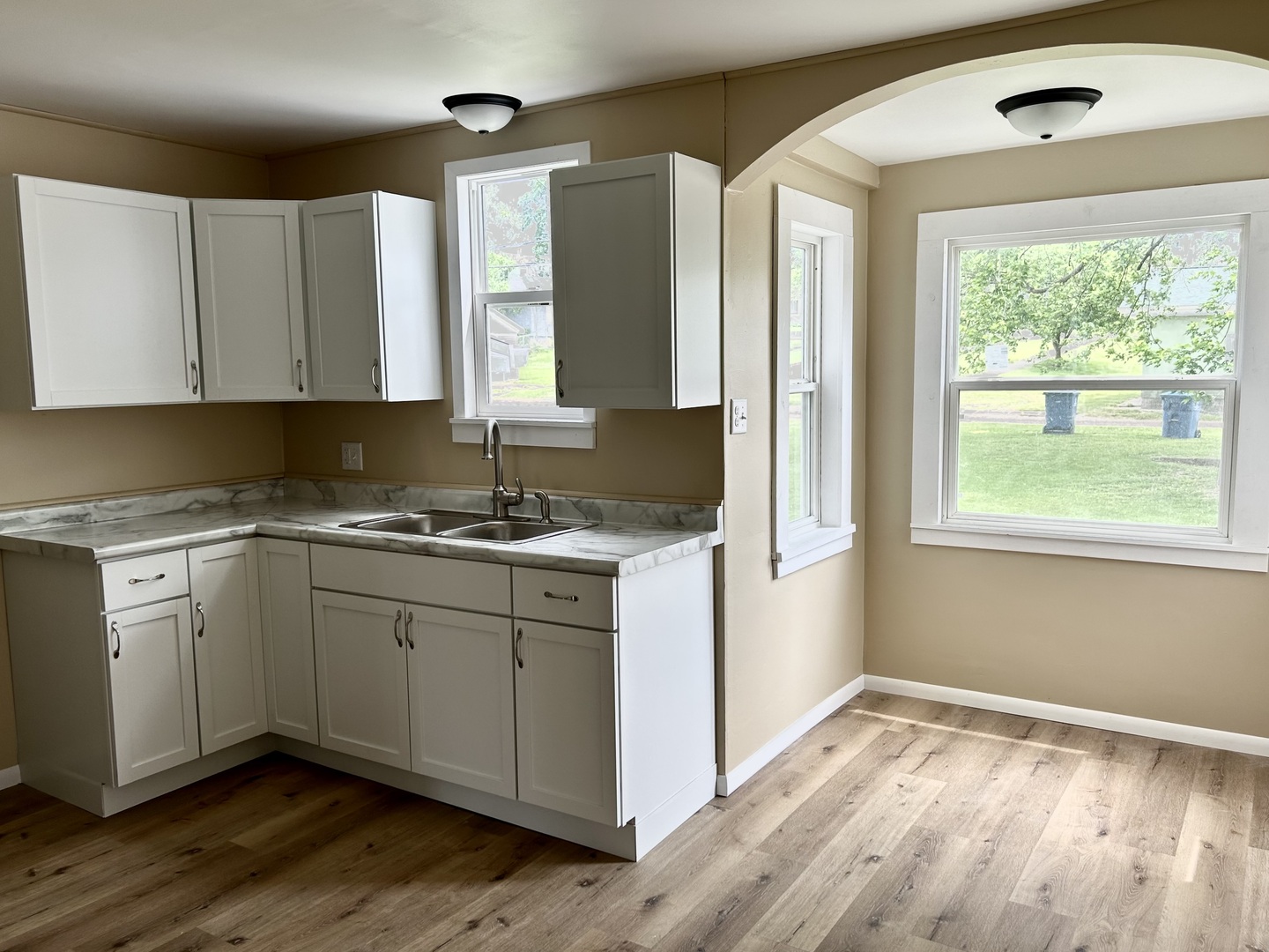 105 West 2nd Street Spring Valley, IL 61362 - Photo 7 of 18 a kitchen with granite countertop wooden cabinets a sink and a window