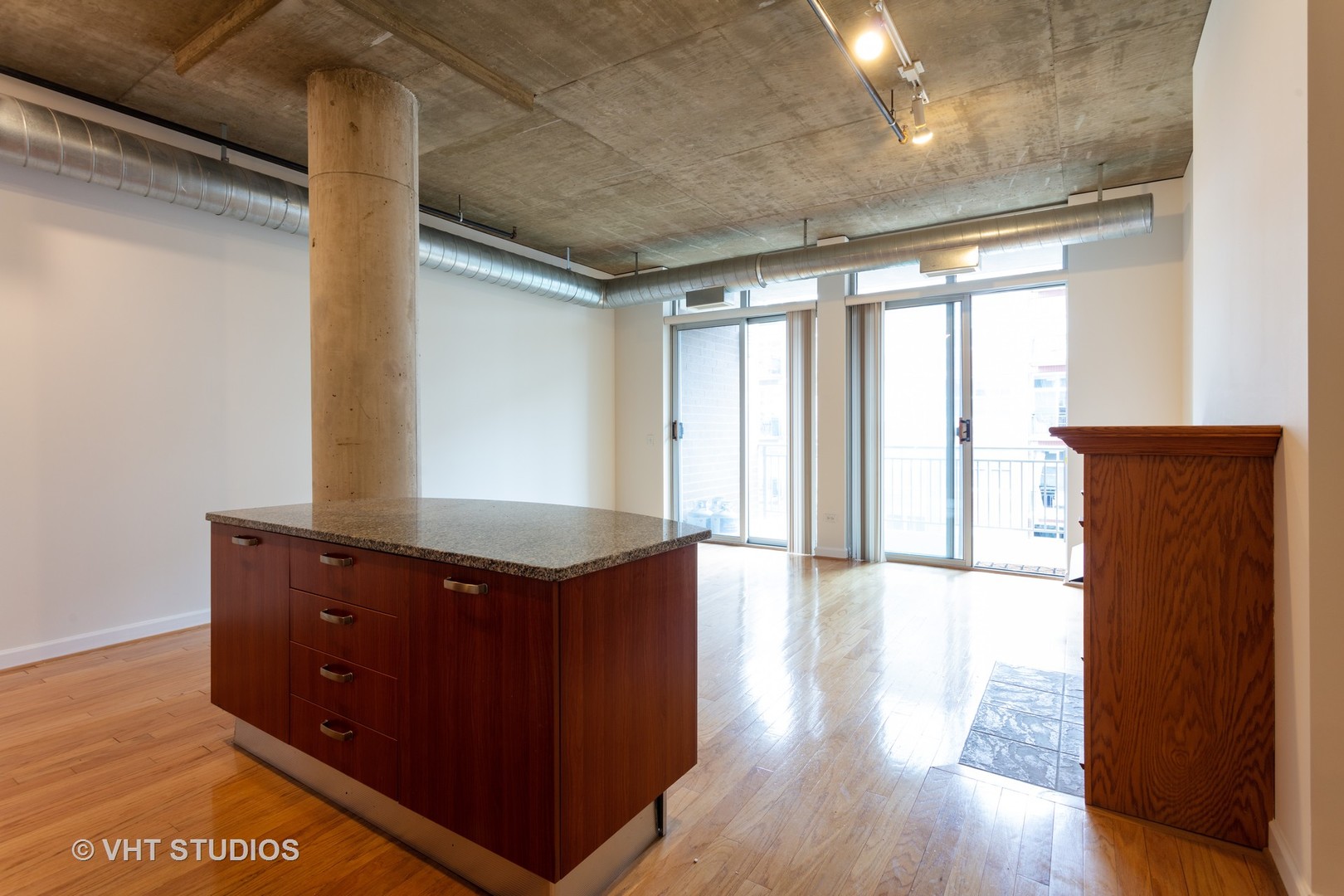 111 South Morgan Street, Unit 609 Chicago, IL 60607 - Photo 3 of 12 a view of an empty room with wooden floor and a window