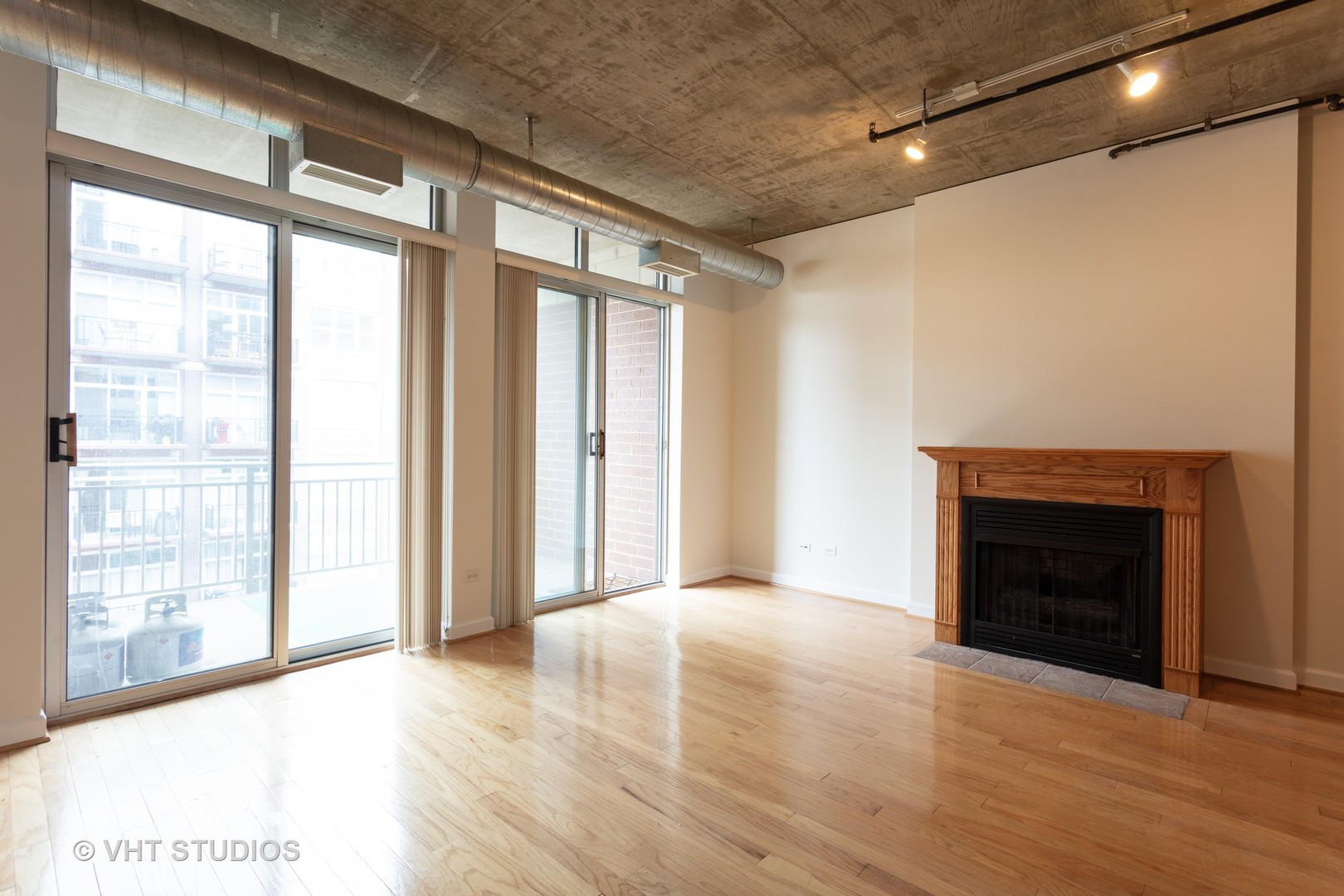 111 South Morgan Street, Unit 609 Chicago, IL 60607 - Photo 5 of 12 a view of an empty room with window and wooden floor