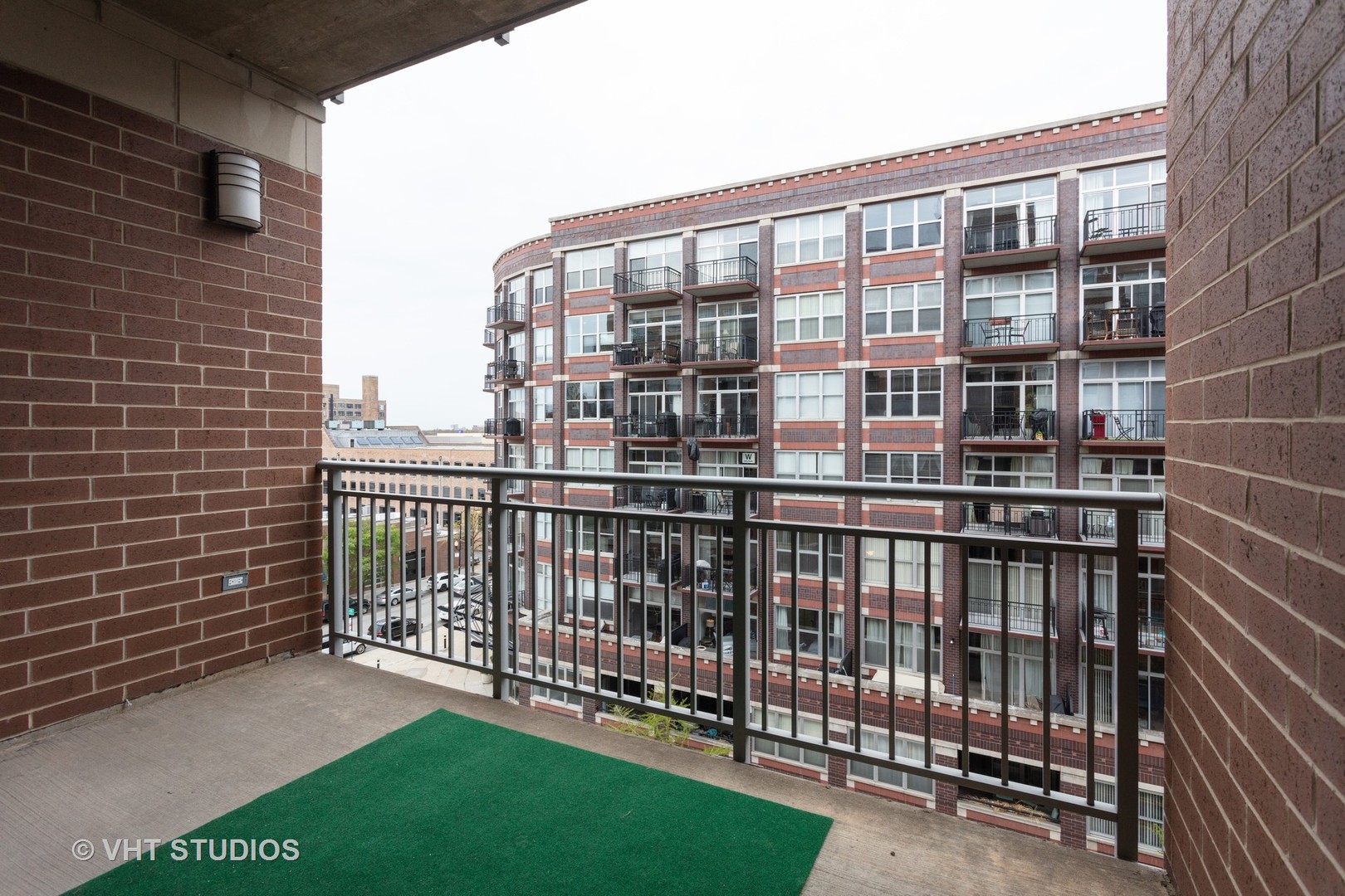 111 South Morgan Street, Unit 609 Chicago, IL 60607 - Photo 6 of 12 a view of a balcony with a floor to ceiling window next to a yard