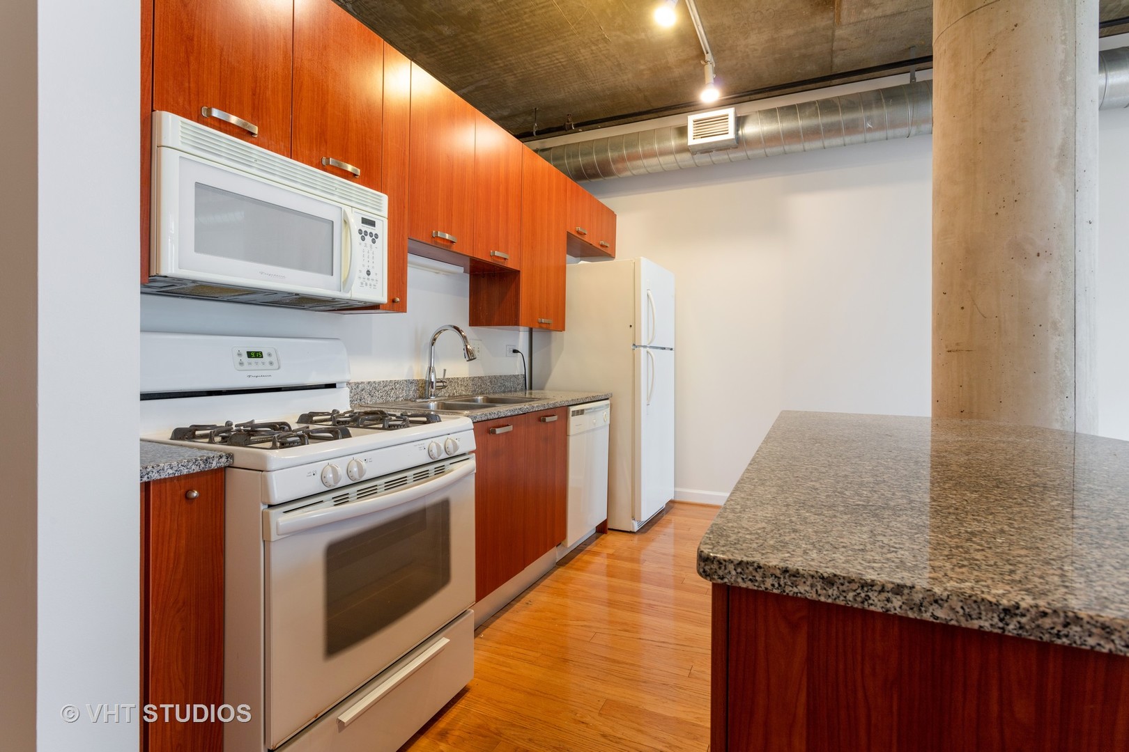 111 South Morgan Street, Unit 609 Chicago, IL 60607 - Photo 8 of 12 a kitchen with granite countertop a sink stainless steel appliances and cabinets