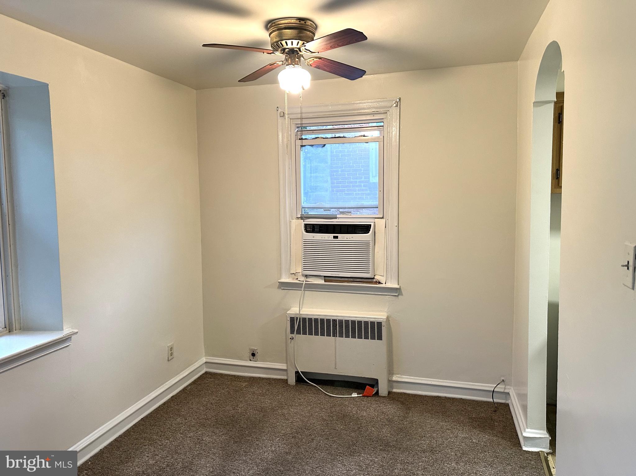 4934 Wynnefield Avenue, Unit 2 Philadelphia, PA 19131 - Photo 5 of 26 an empty room with windows and fan