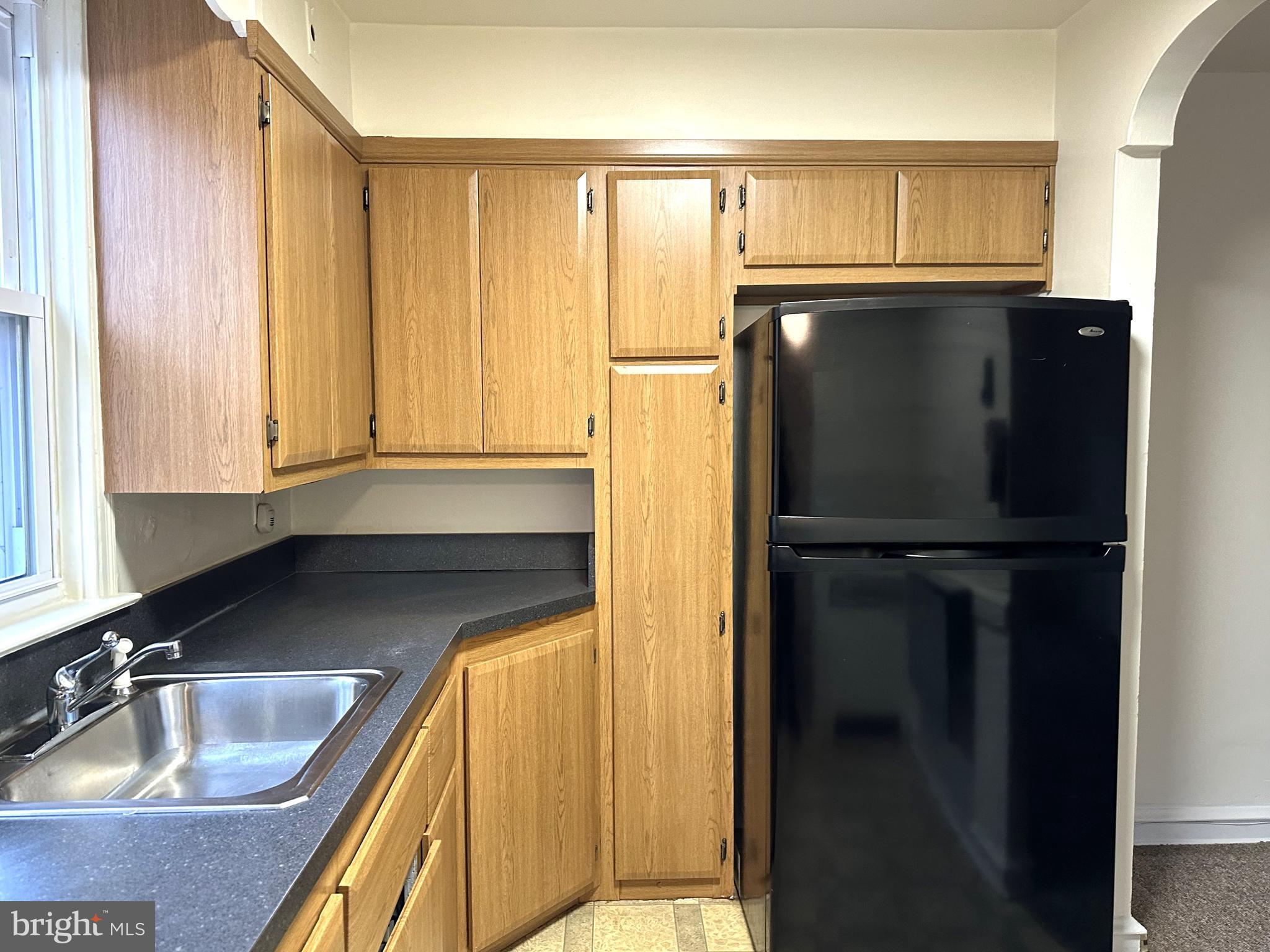 4934 Wynnefield Avenue, Unit 2 Philadelphia, PA 19131 - Photo 6 of 26 a kitchen with a refrigerator and a sink