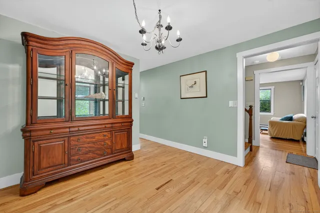 a living room with wooden floors and a ceiling fan