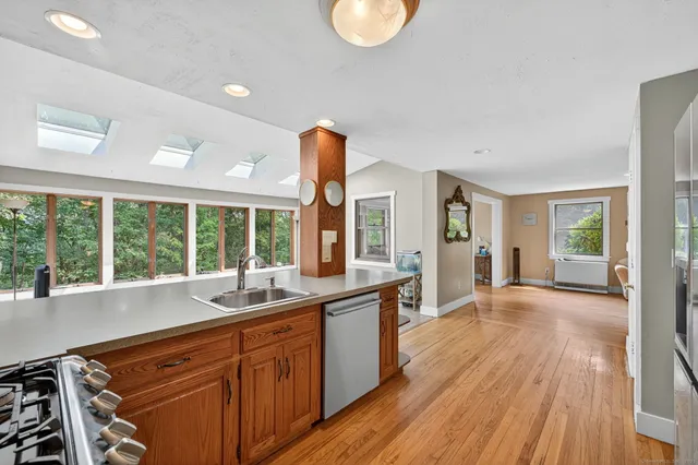 a view of a kitchen with a sink and large window
