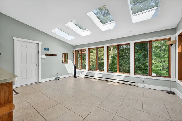 a living room with furniture and large windows