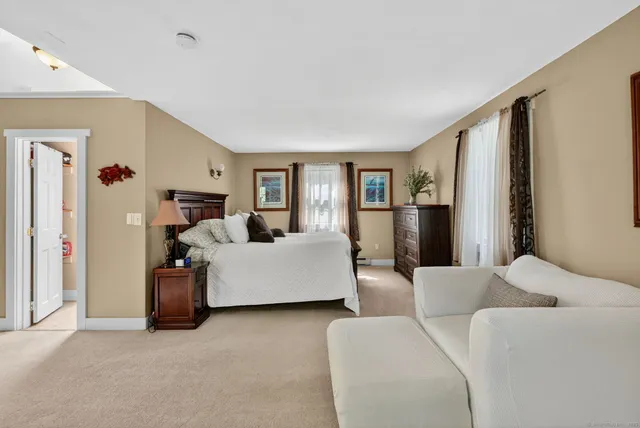 a bed room with a bed and a large window