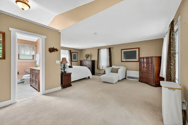 a bathroom with a granite countertop sink a toilet and a mirror