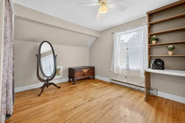 a bathroom with a granite countertop sink a toilet and a mirror