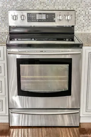 a stove top oven sitting inside of a kitchen