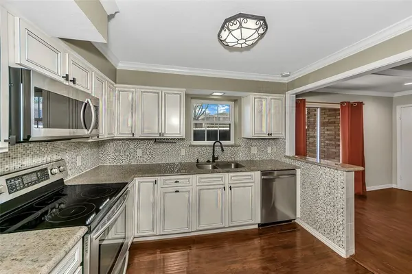 a kitchen with a sink stove top oven and cabinets