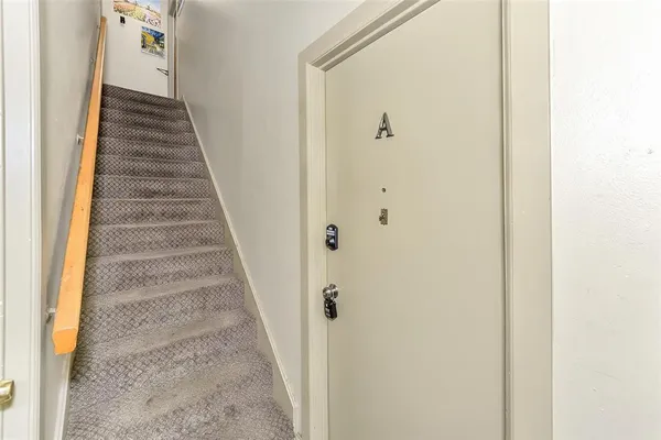 a view of a hallway with stairs