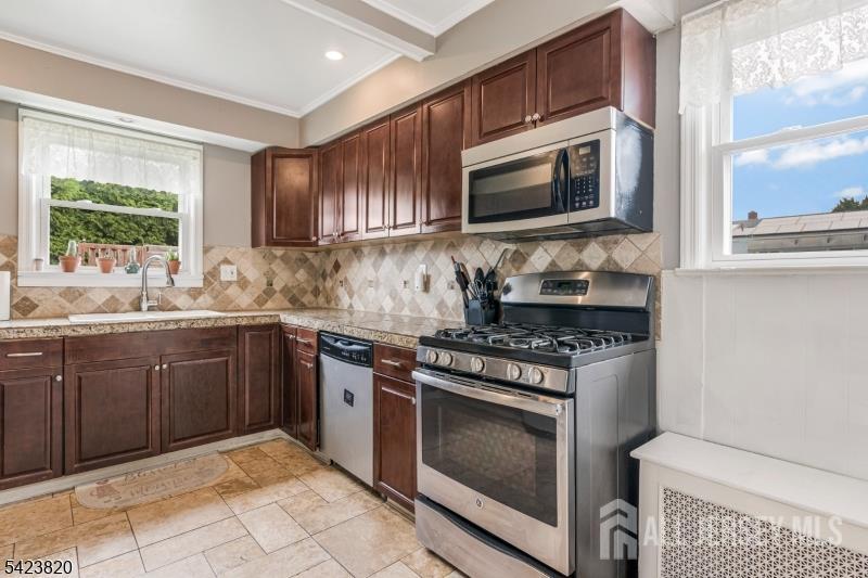 110 Parker Street Middlesex, NJ 08846 - Photo 11 of 25 a kitchen with stainless steel appliances granite countertop a stove microwave and sink