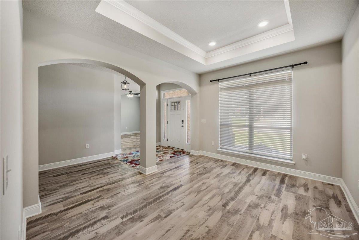 8056 Stream Ridge Road Pensacola, FL 32526 - Photo 12 of 66 a view of an empty room with wooden floor and a window