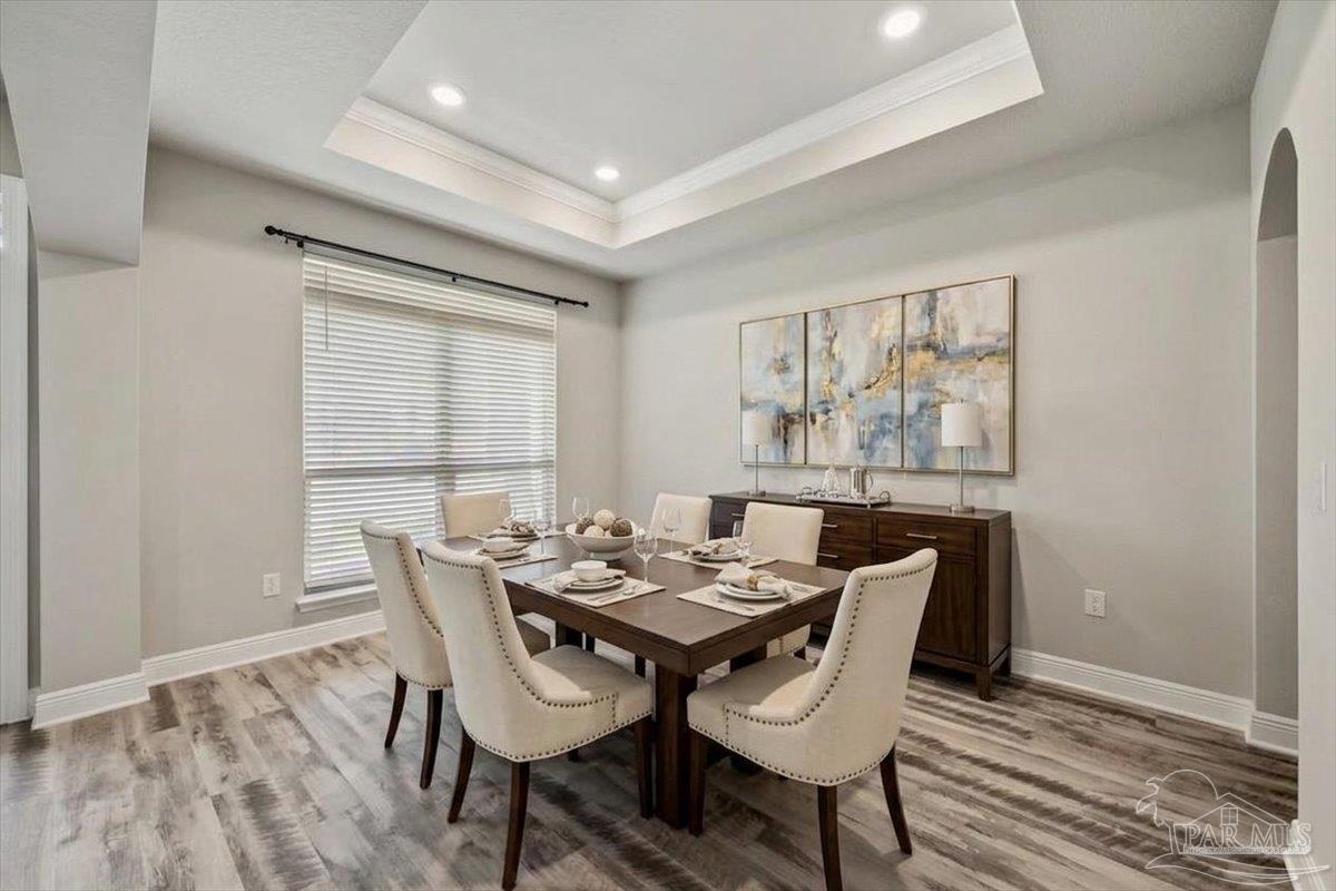 8056 Stream Ridge Road Pensacola, FL 32526 - Photo 13 of 66 a view of a dining room with furniture large window and wooden floor