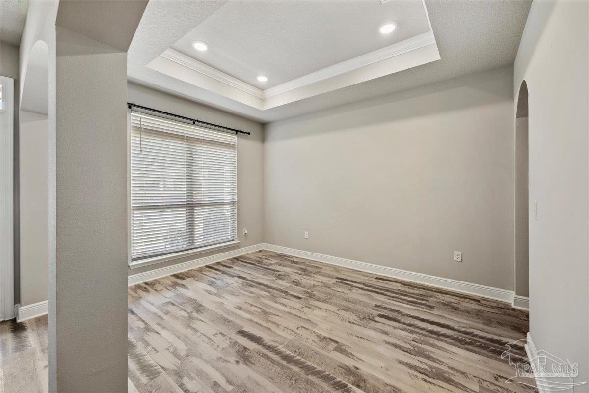 8056 Stream Ridge Road Pensacola, FL 32526 - Photo 14 of 66 an empty room with wooden floor and windows