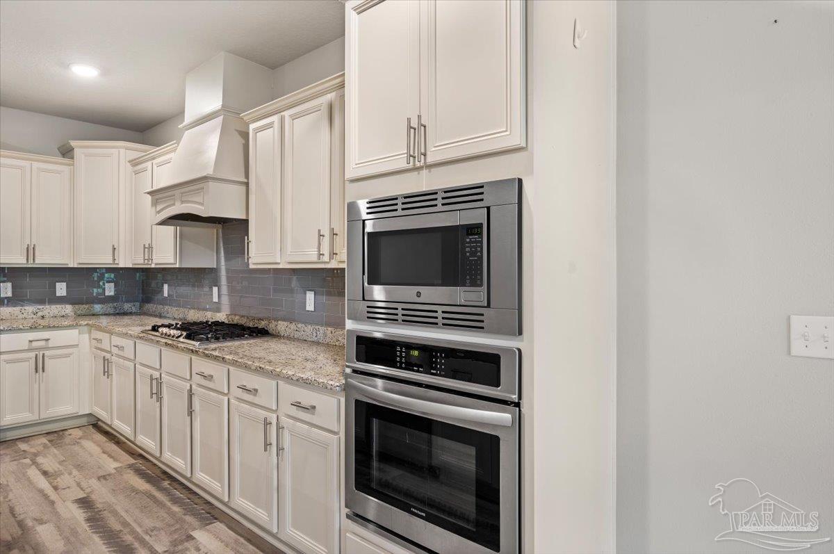 8056 Stream Ridge Road Pensacola, FL 32526 - Photo 25 of 66 a kitchen with stainless steel appliances granite countertop a stove top oven and sink