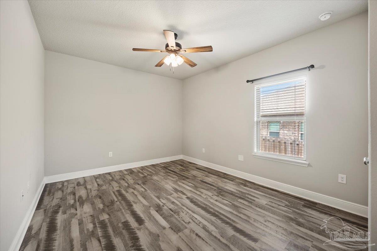 8056 Stream Ridge Road Pensacola, FL 32526 - Photo 32 of 66 an empty room with windows and fan