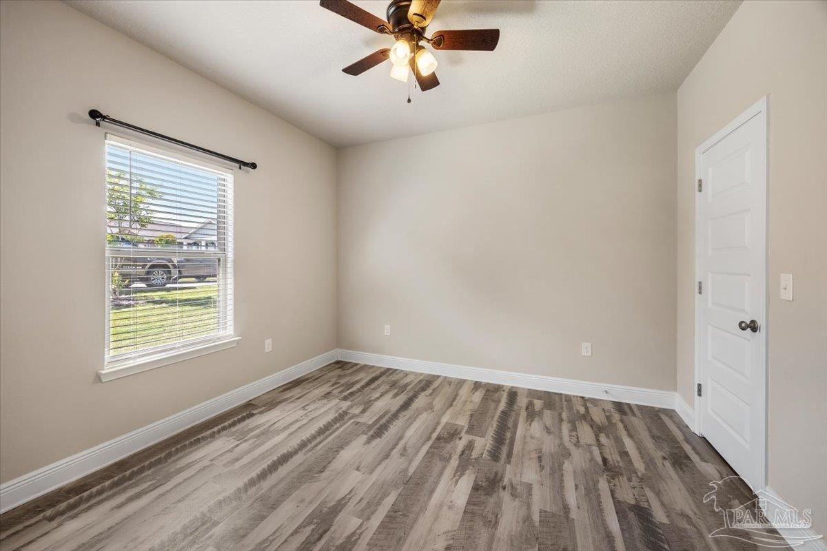 8056 Stream Ridge Road Pensacola, FL 32526 - Photo 37 of 66 wooden floor in an empty room with a window