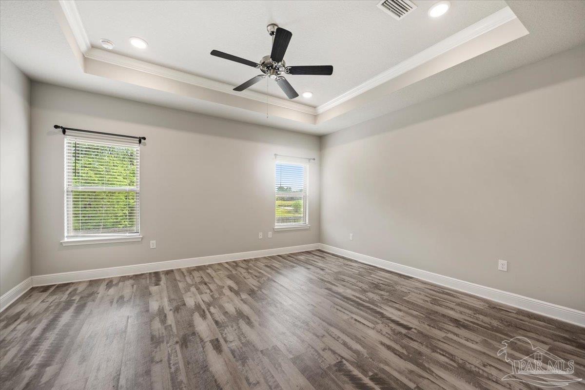 8056 Stream Ridge Road Pensacola, FL 32526 - Photo 42 of 66 an empty room with wooden floor ceiling fan and windows