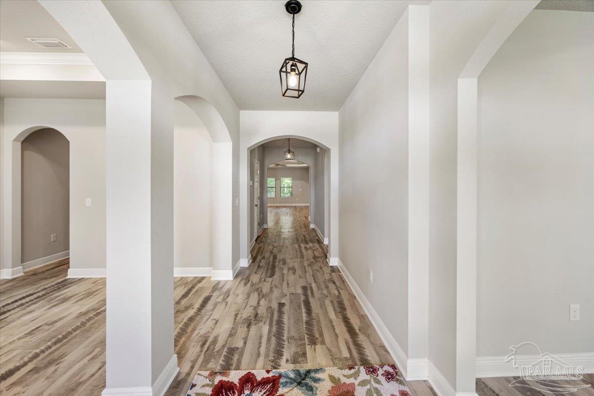 8056 Stream Ridge Road Pensacola, FL 32526 - Photo 7 of 66 a view of a hallway view with wooden floor and staircase