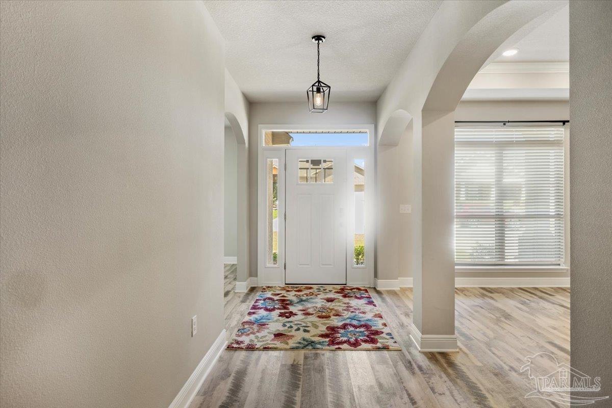 8056 Stream Ridge Road Pensacola, FL 32526 - Photo 8 of 66 a view of a hallway view with wooden floor and staircase