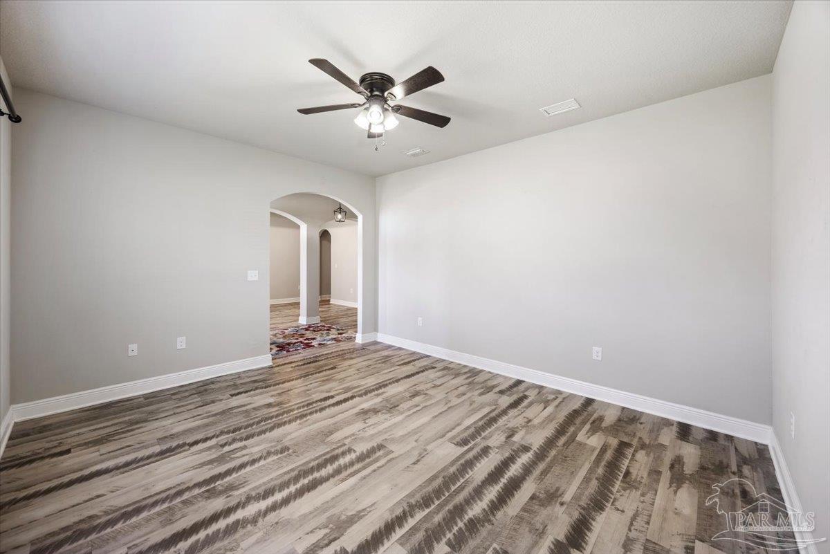 8056 Stream Ridge Road Pensacola, FL 32526 - Photo 10 of 66 wooden floor in an empty room with a window