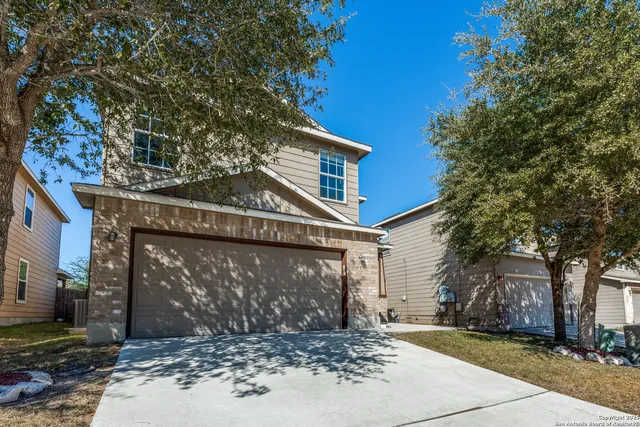 a view of a house with a tree