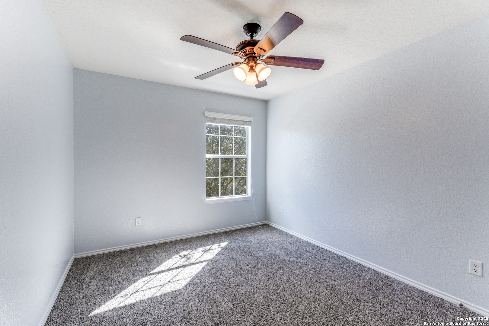 455 Walnut Crest Schertz, TX 78154 - Photo 16 of 30 an empty room with a window and a fan