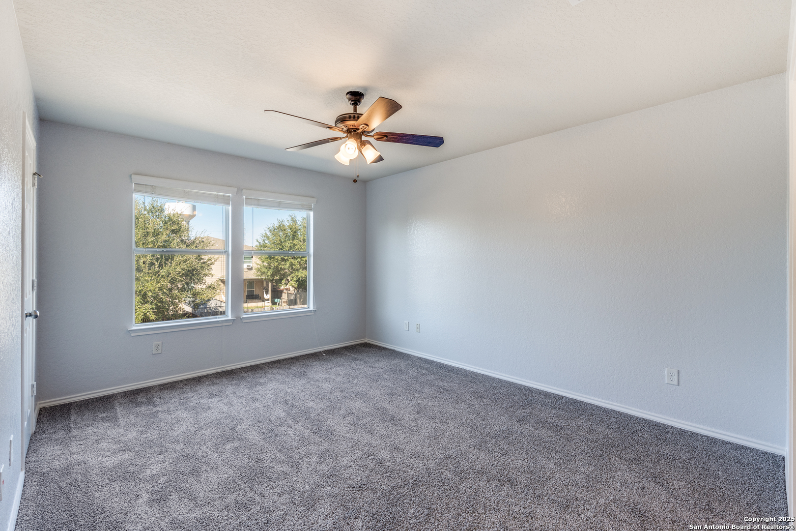 455 Walnut Crest Schertz, TX 78154 - Photo 20 of 30 an empty room with windows and chandelier fan