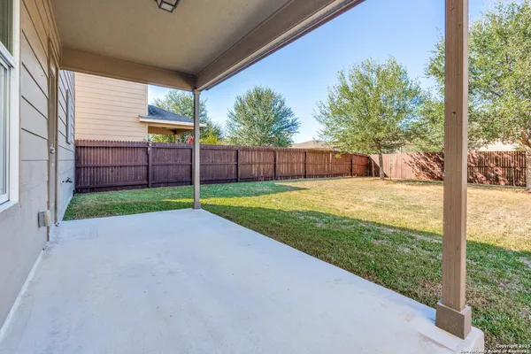 a view of a house with backyard and porch